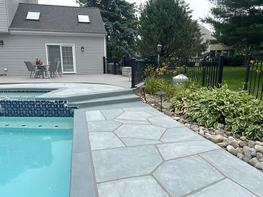 Pool deck resurfaced in Granite Boulder finish with durable resurfaced concrete
