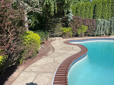 Sandstone concrete pool deck repair featuring light, warm stone aesthetic