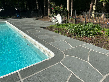 Resurfaced concrete pool deck in Granite Slate finish showing modern gray stone appearance.