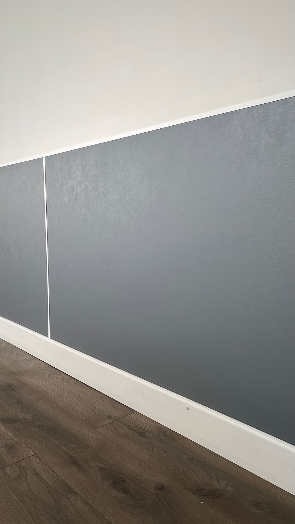 Thumbnail: EnduraFlood UNI-BASE waterproof base trim installed at the bottom of ENDU-BOARD wall panels