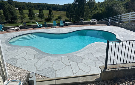 RenuKrete resurfaced pool deck in Granite Boulder showing durable resurfaced concrete