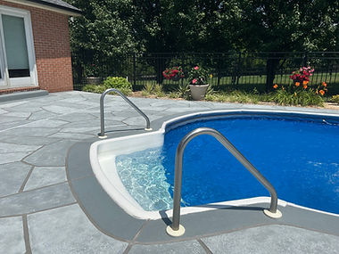 RenuKrete resurfaced pool deck in Granite Boulder showing natural boulder-inspired appearance