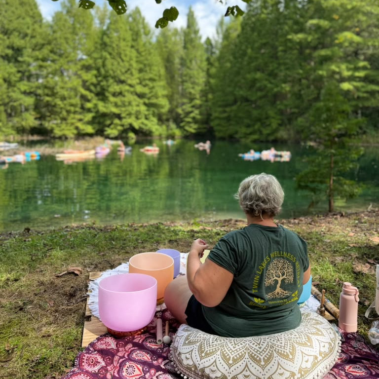 Guests relaxing on a floating sound bath at a Twin Lakes Wellness Retreat