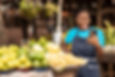a market woman looking into her phone.jpg