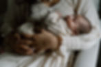 A newborn lays against his mother’s chest during a Gig Harbor family photo session
