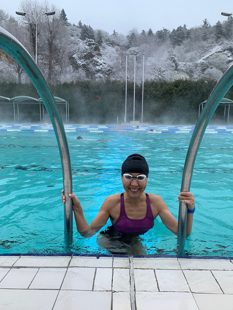 Girl entering pool in winter