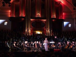 orchestra on stage with conductor