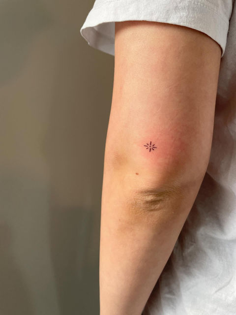Small minimal tattoo on female elbow