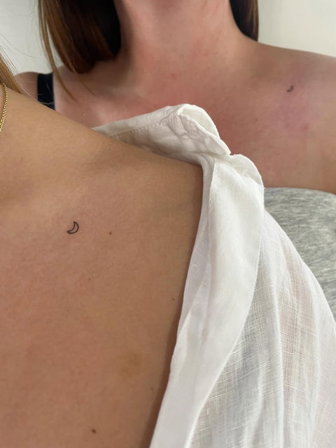Two female shoulders with tattoos