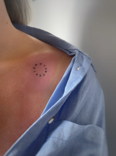 Small dot circle tattoo on shoulder