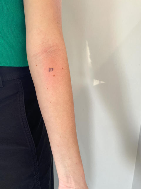 freckle tattoo on forearm