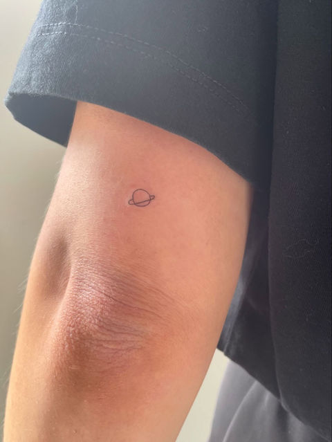 freckle tattoo on female tricep