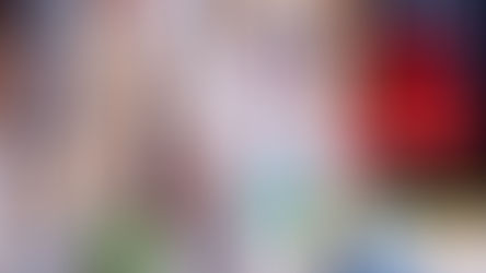 Worker in hazmat suit and respirator handling hazardous chemicals with proper PPE protection