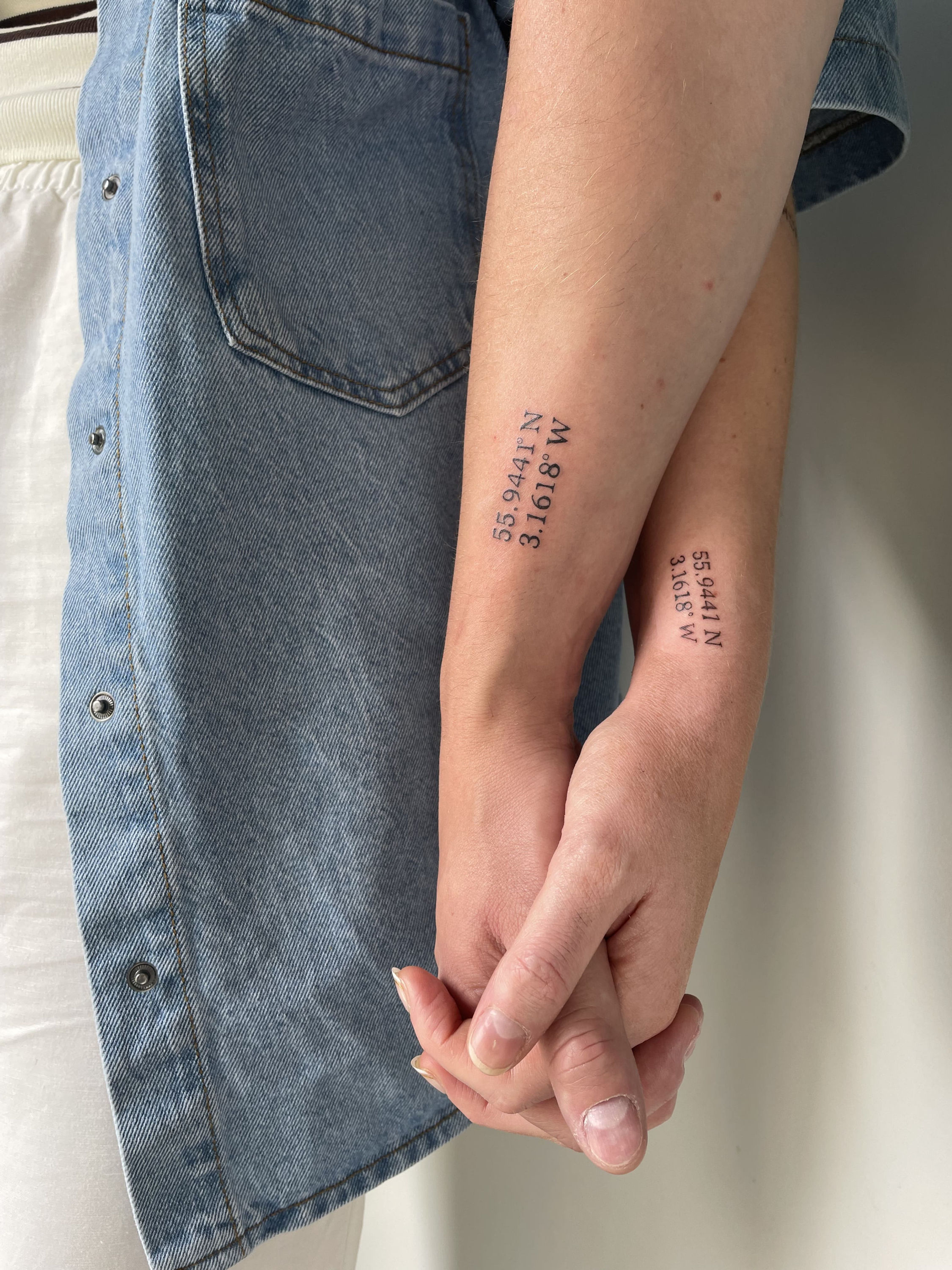 minimal floral fine line tattoo on female forearm