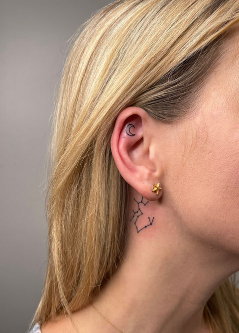 Woman with blonde hair and small neck tattoo