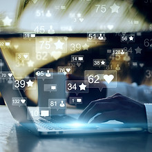 Side view and close up of businessman hands using laptop with social media icons on blurry