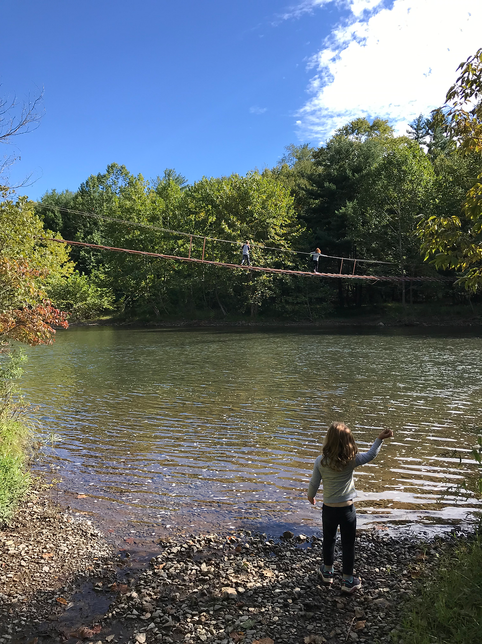 Two children cross a suspension bridge in Benezette, PA