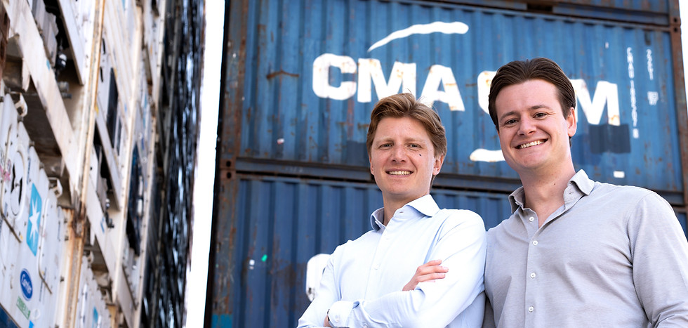 De twee eigenaren die voor containers staan lachend