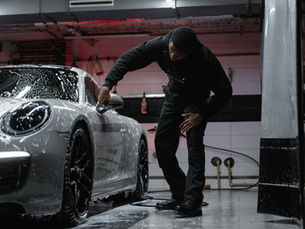 Car Bae Mysore detailing professional applying ceramic coating on a shiny car, highlighting the difference between car polish and ceramic coating for long-term paint protection.