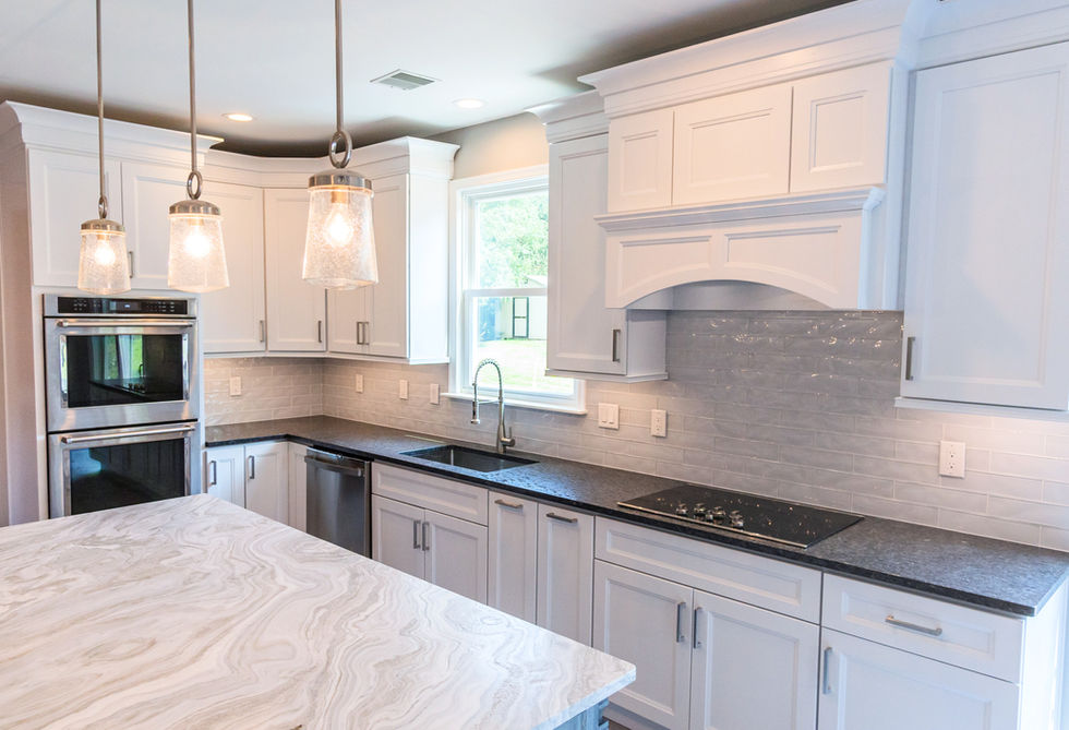 Modern kitchen with white cabinetry and updated appliances
