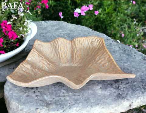 Enhance your hotel's dining presentation with BAFA's Crumbled Paper Platter. Designed for both style and functionality, these ceramic stoneware platters offer a unique crumbled paper texture, adding a touch of elegance to any table setting. They are dishwasher and microwave safe, lead-free, and crafted to be twice as durable, ensuring longevity. Customize them with your preferred finish to suit your hotel's aesthetic effortlessly