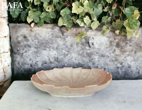 Introducing our Beige Shell-Shaped Serving Bowl by BAFA, perfect for enhancing the dining experience in your hotel. Crafted from premium ceramic stoneware, this elegant bowl features a unique shell-inspired design that adds a touch of coastal charm to any table setting. Its versatile size and shape make it ideal for serving a variety of dishes, from salads to pasta and more. Designed with functionality in mind, our serving bowl is dishwasher safe, microwave safe, and lead-free, ensuring convenience and safety for your guests. With twice the durability of standard crockery, it withstands the rigors of daily use in a hotel environment. Furthermore, it can be customized to any finish, allowing you to tailor it to complement your hotel's aesthetic seamlessly. Elevate your dining presentation with our Beige Shell-Shaped Serving Bowl by BAFA
