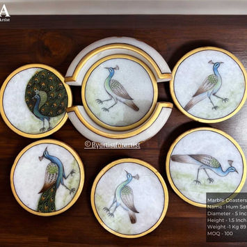Exquisite Marble Meenakari Coaster Stand with Round Coasters featuring a beautifully hand-painted peacock design and a luxurious golden border. Expertly crafted with traditional Meenakari artistry, this elegant set adds a touch of royalty and sophistication to any table setting. Perfect for home décor, gifting, and festive celebrations