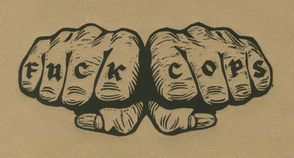 Two fists with tattooed knuckles that says “fuck cops.”
