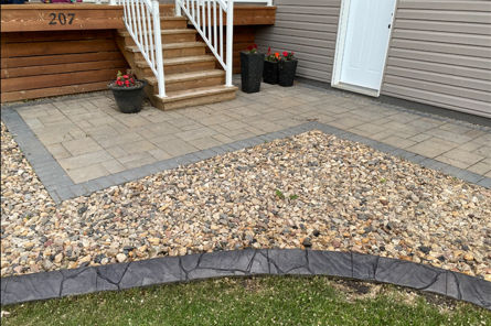 Concrete landscape curbing installation in Hanley, Saskatchewan by Prairie Curbs & Surface Solutions.