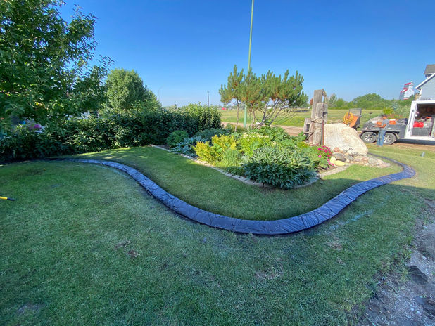 Decorative stamped curbing by Prairie Curbs for improved property value in Hanley, SK.