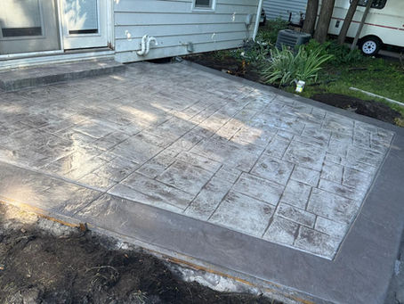 Concrete Patio Stamped and Colored in light and dark grey color accents, with a slate stamp to create a paver look in the new concrete. Installed by local minnesota installer