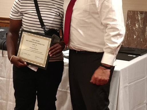 Apprentice receiving graduation certificates.