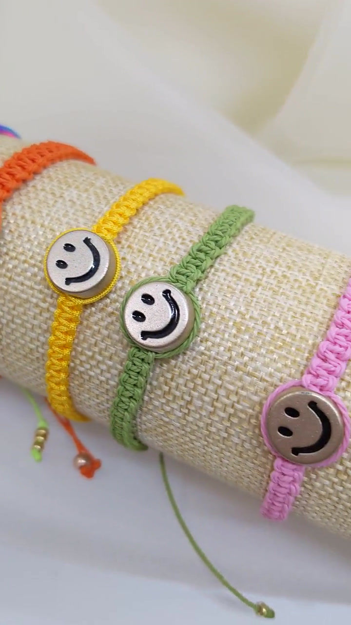 Thumbnail: colorful macrame bracelets on a tube