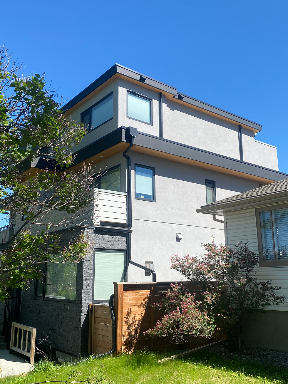 Exterior stucco repair on a Calgary residential home under clear daylight