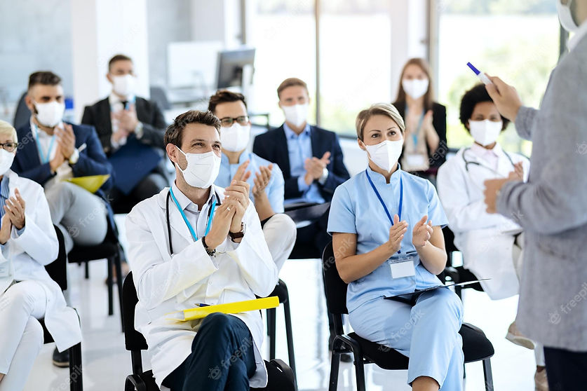 healthcare-workers-business-people-wearing-face-masks-applauding-seminar_637285-9140.jpg