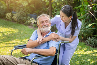happy-nurse-holding-elderly-man-hand-wheelchair-garden-nursing-home_554837-197-transformed