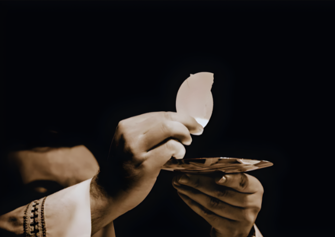 Priest raising the Holy Eucharist