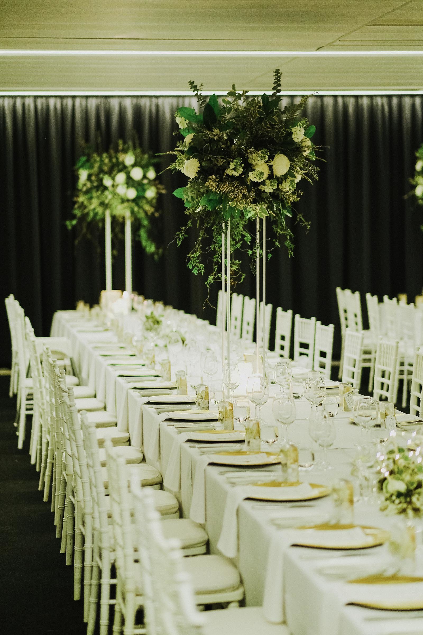 White & green flowers on table stands