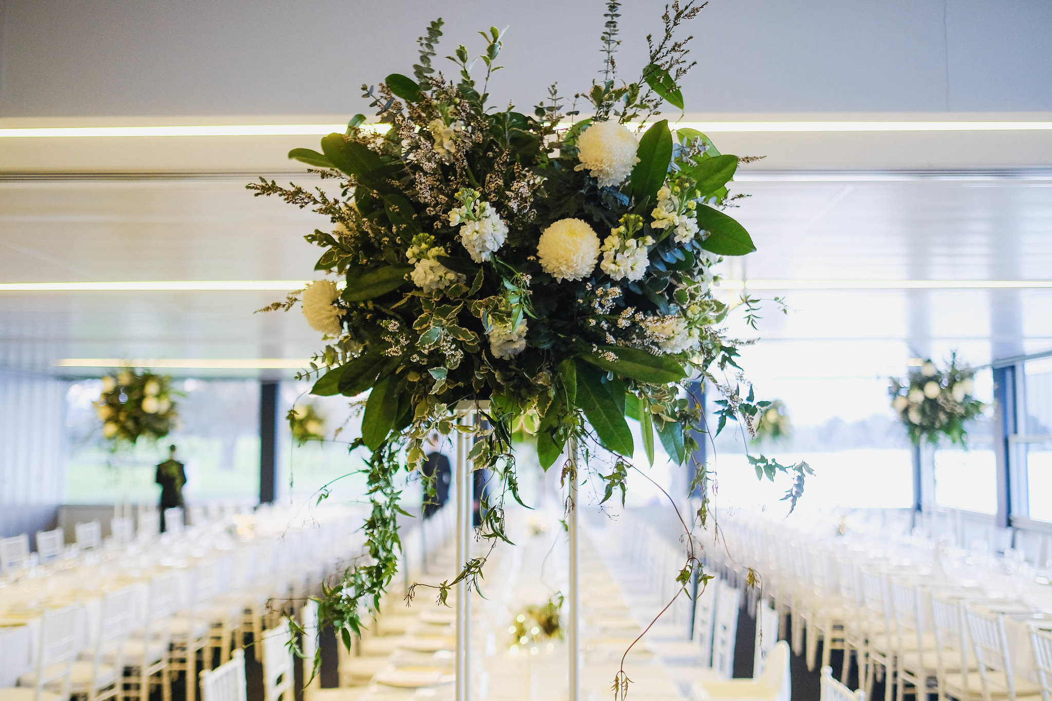 White & green flowers on table stands