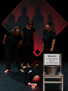 ARTOM performers with red geometric projection and stage props