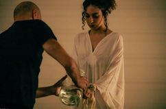 Female performer in white during METAMORFOSI