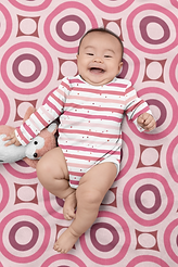 onesie-mockup-of-a-cheerful-baby-lying-on-a-customizable-blanket-30050 (1).png