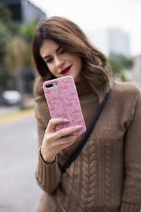 mockup-of-an-iphone-case-held-by-a-pretty-woman-wearing-a-sweater-22912.png