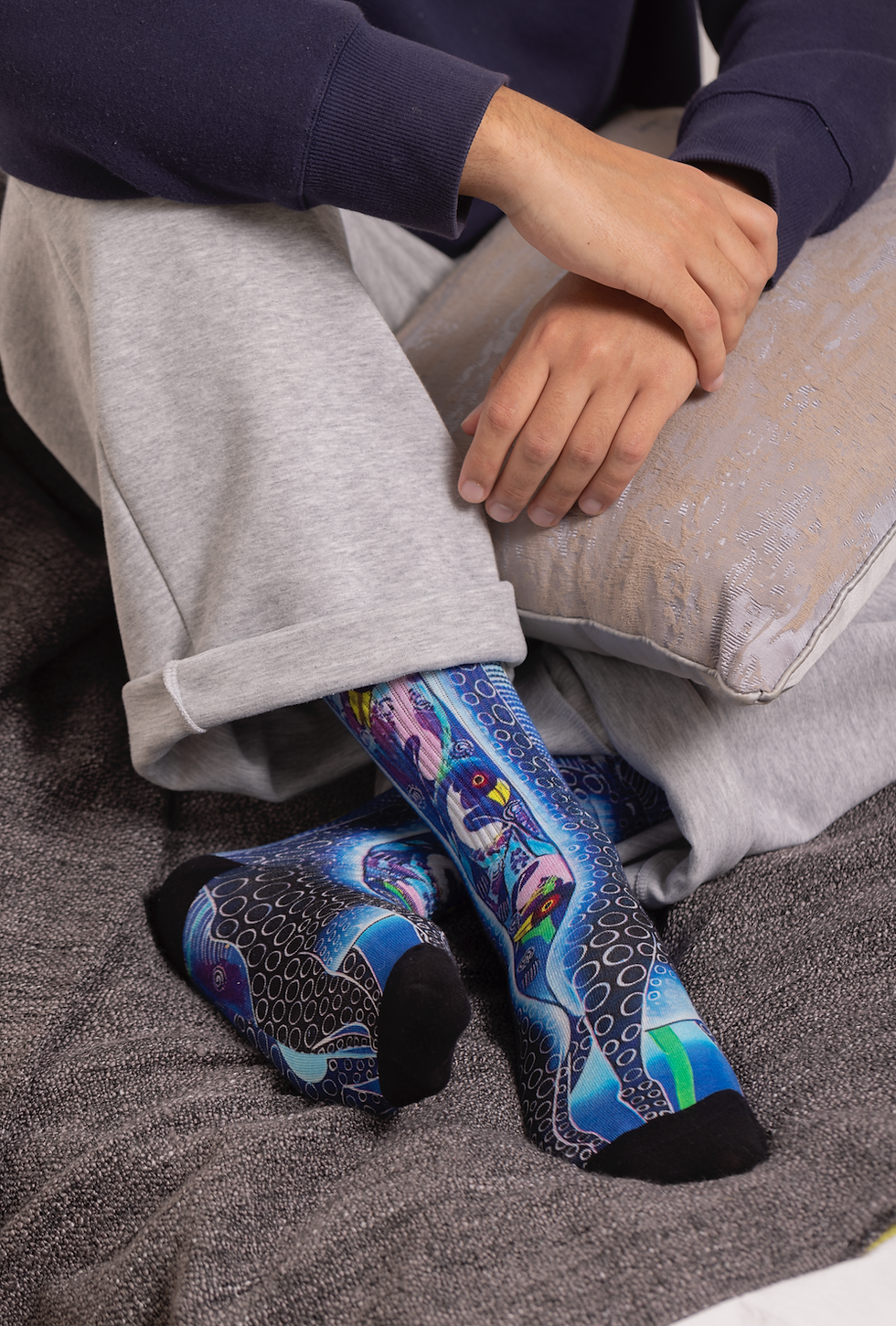 man wearing ethical socks called purple giraffe sababu socks whilst crossing his legs