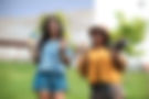 about us - domestic helper holding sababu socks on a green field_edited.jpg