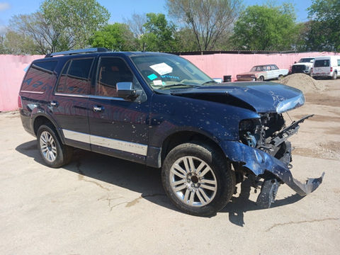 Totaled Lincoln Navigator SUV with major body damage.