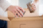 Food cans being placed in a carton