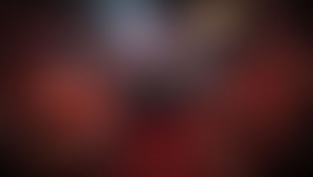 Hero wielding guns, firing at shadows in a dark, red chamber. Chains and mystical figures above. Text: Torchlight Infinite, Vorax. Intense mood.