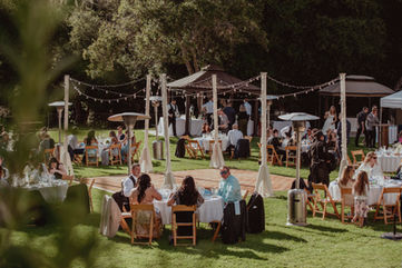Outdoor wedding reception with dance floor and wood chairs at amphitheater of the redwoods at pema osel ling