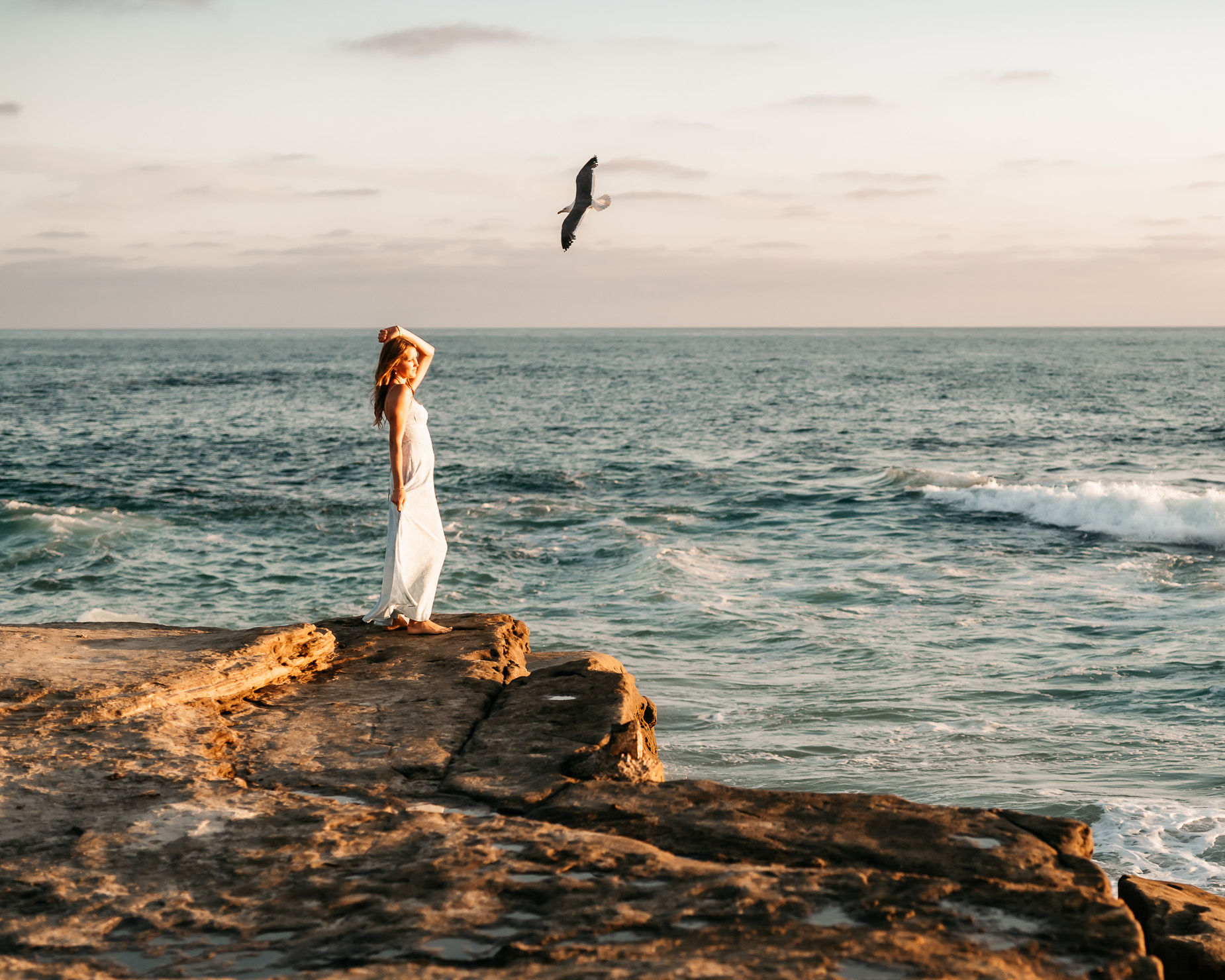 HS senior at the beach in white dress